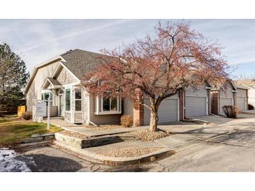 Cute exterior of townhome with attached garage and landscaping at 8525 S Upham Way, Littleton, CO 80128