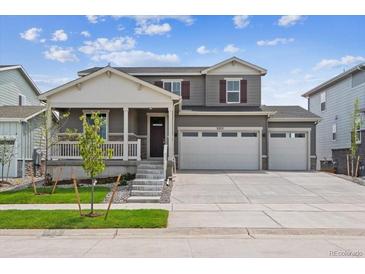 Two-story home with gray siding, white trim, and a three-car garage at 3322 N Highlands Creek Pkwy, Aurora, CO 80019