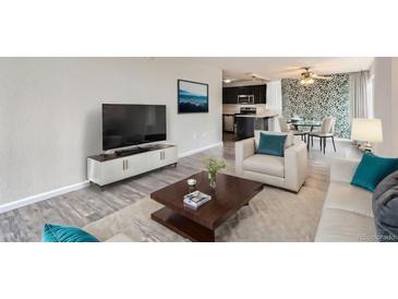Bright living room features hardwood floors and an open concept layout at 909 N Logan St # 4A, Denver, CO 80203