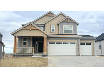 Two-story house with gray siding, beige accents, and a two-car garage at 39610 Congress Ln, Elizabeth, CO 80107