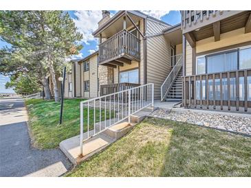Tan condo building with stairs and balcony at 1777 S Pitkin St # B, Aurora, CO 80017