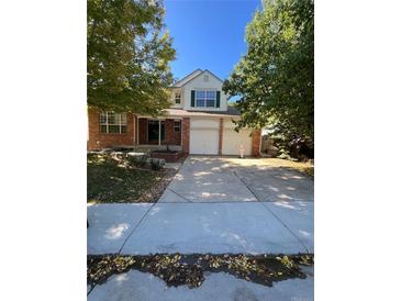 Two-story brick home with attached two-car garage at 15626 Greenstone Cir, Parker, CO 80134