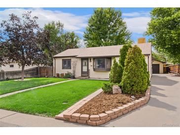 Ranch style home with a well-manicured lawn and mature trees at 1325 S Vrain St, Denver, CO 80219