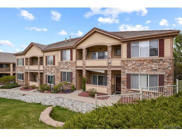 Multi-unit building featuring stone and siding accents with landscaping at 22960 E Roxbury Dr # G, Aurora, CO 80016
