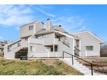 Exterior view of a multi-level condo building with landscaping at 8701 Huron St # 1-210, Thornton, CO 80260