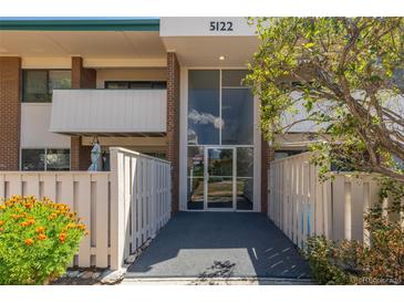 Condo building entrance with landscaping and walkway at 5122 Williams Fork Trl # 201, Boulder, CO 80301