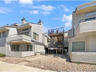 Condo building with multiple units, showing parking and building access at 1830 Newland Ct # 323, Lakewood, CO 80214