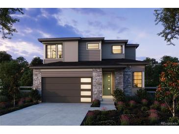 Two-story home with stone accents and landscaped front yard at 8870 Whiteclover St, Littleton, CO 80125