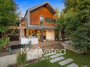 Modern two-story home with a large deck and landscaped backyard at 1253 Elizabeth St, Denver, CO 80206