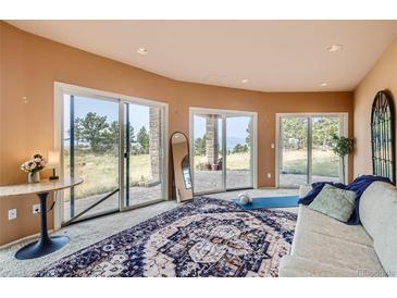 Living room with sliding doors to patio and scenic views at 3001 Eagle Ridge Rd, Longmont, CO 80503