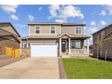 Two-story home with a front porch, attached garage, and landscaped yard at 4213 Sandstone Dr, Mead, CO 80504