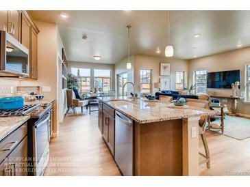 Open concept kitchen with island and granite countertops at 830 W 128Th Pl, Westminster, CO 80234