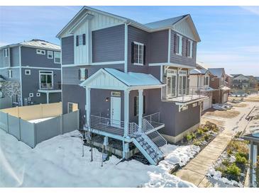 Modern two-story home with snow covered walkway at 4072 N Rome St, Aurora, CO 80019