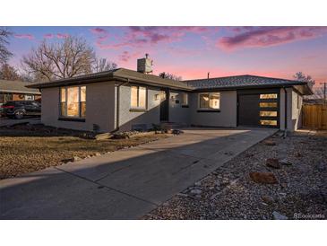 Updated ranch home with modern garage door and landscaping at 840 Marble St, Broomfield, CO 80020