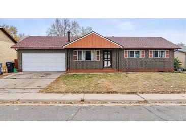 Brick ranch home with attached garage and mature landscaping at 14830 Robins Dr, Denver, CO 80239