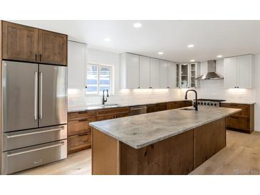 Modern kitchen with stainless steel appliances and large island at 824 W Geddes Cir, Littleton, CO 80120
