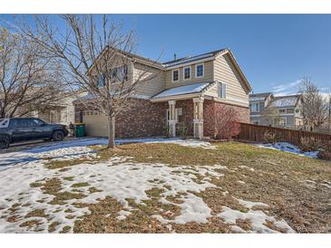 Two-story house exterior with snowy yard at 19608 E 58Th Pl, Aurora, CO 80019