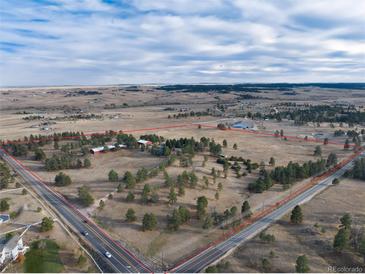 Aerial view of a large lot with a house and outbuildings at 3074 County Road 166, Elizabeth, CO 80107
