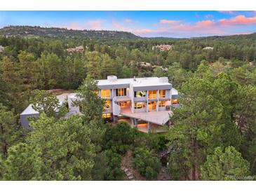 Luxury home nestled in a wooded area with mountain views at 7 Elk Pointe Ln, Castle Rock, CO 80108