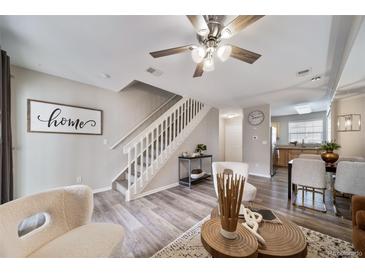 Bright living room with hardwood floors and staircase at 17273 E Ford Dr, Aurora, CO 80017