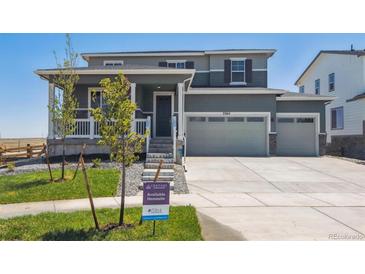 Two-story home with two-car garage and welcoming porch at 3362 N Highlands Creek Pkwy, Aurora, CO 80019