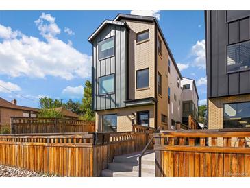 Modern three-story home with metal siding and brick accents at 1415 Irving St, Denver, CO 80204