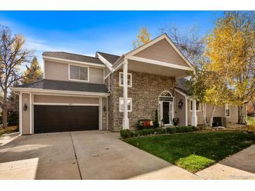 Two-story home with stone accents and a landscaped yard at 107 Fairfield Ln, Louisville, CO 80027