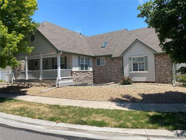 Charming ranch home with stone exterior and front porch at 1266 S Ammons St, Lakewood, CO 80232