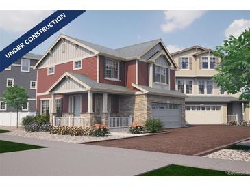 Two-story home with red siding, stone accents, and a two-car garage at 1224 Sugarloaf Ln, Erie, CO 80516