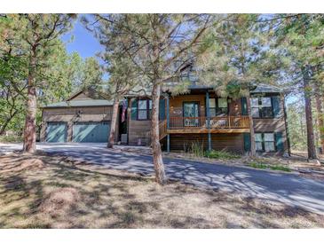 Two-story home with a three-car garage and mountain views at 1065 Independence Dr, Larkspur, CO 80118