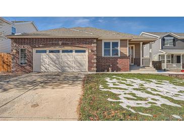 Brick ranch home with attached garage and landscaped yard at 6327 S Miller Ct, Littleton, CO 80127