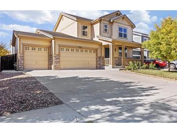 Two-story house with a three-car garage and landscaped yard at 11735 Helena St, Commerce City, CO 80022