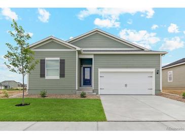 Green house exterior with 2-car garage at 2144 Alyssa St, Fort Lupton, CO 80621