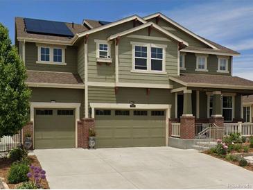 Two-story house with green siding, brown roof, and a three-car garage at 7899 S Country Club Pkwy, Aurora, CO 80016