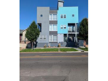 Modern three-story building with gray and teal exterior at 3450 N Downing St # 3, Denver, CO 80205