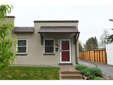 Charming stucco home with red door and steps leading to the entrance at 2660 Utica St, Denver, CO 80212