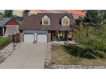 Brick house with two-car garage and landscaping at 3905 E 134Th Ct, Thornton, CO 80241