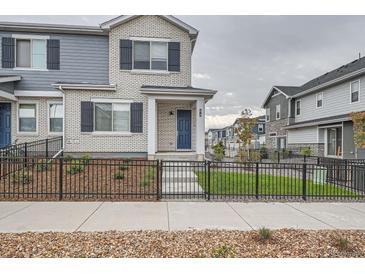 Two-story townhouse with gray and white brick exterior at 27472 E 1St Ave, Aurora, CO 80018