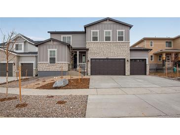 Two-story home with gray siding and stone accents at 3452 N Gold Bug Ct, Aurora, CO 80019