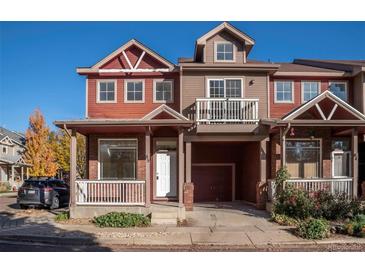 Two-story townhome with a red brick facade and a front porch at 818 S Terry St # 85, Longmont, CO 80501