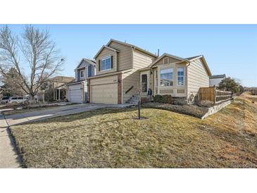 Two-story house with attached garage and landscaped yard at 3944 Morning Glory Dr, Castle Rock, CO 80109