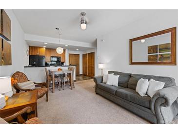 Spacious living room with fireplace and access to a deck at 34 Highfield Trl # 203, Breckenridge, CO 80424