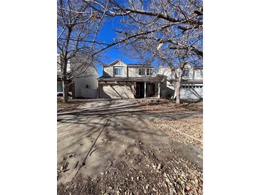 Two-story house with attached garage and landscaping at 4361 Argonne St, Denver, CO 80249