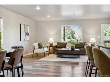 Bright living room features hardwood floors, modern furniture, and large windows at 3225 N Olive St, Denver, CO 80207