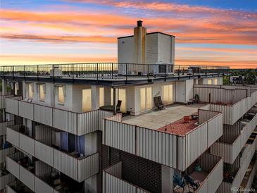 An aerial view of a multi-level building with balconies and rooftop decks at 1313 Steele St # 801, Denver, CO 80206