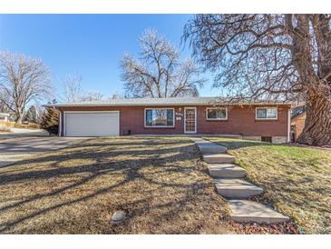 Brick ranch home with attached garage and landscaped yard at 2800 S Yates St, Denver, CO 80236