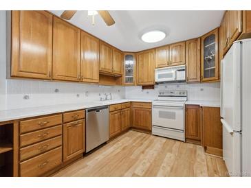Bright kitchen with light wood cabinets and appliances at 660 S Alton Way # 5C, Denver, CO 80247