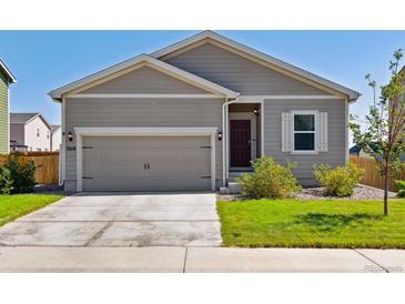 Tan one-story house with a two-car garage and landscaped yard at 7418 Blue River Ave, Frederick, CO 80530