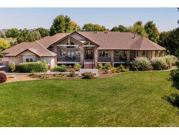 Ranch-style home on a spacious lot with mature landscaping and a large yard at 385 Baxter Farm Ln, Erie, CO 80516