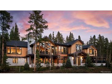 Luxury mountain home with expansive windows and a large deck at 72 Dyer Trl, Breckenridge, CO 80424